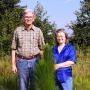 Tim and Harriette Allen standing in front of long leaf pines.